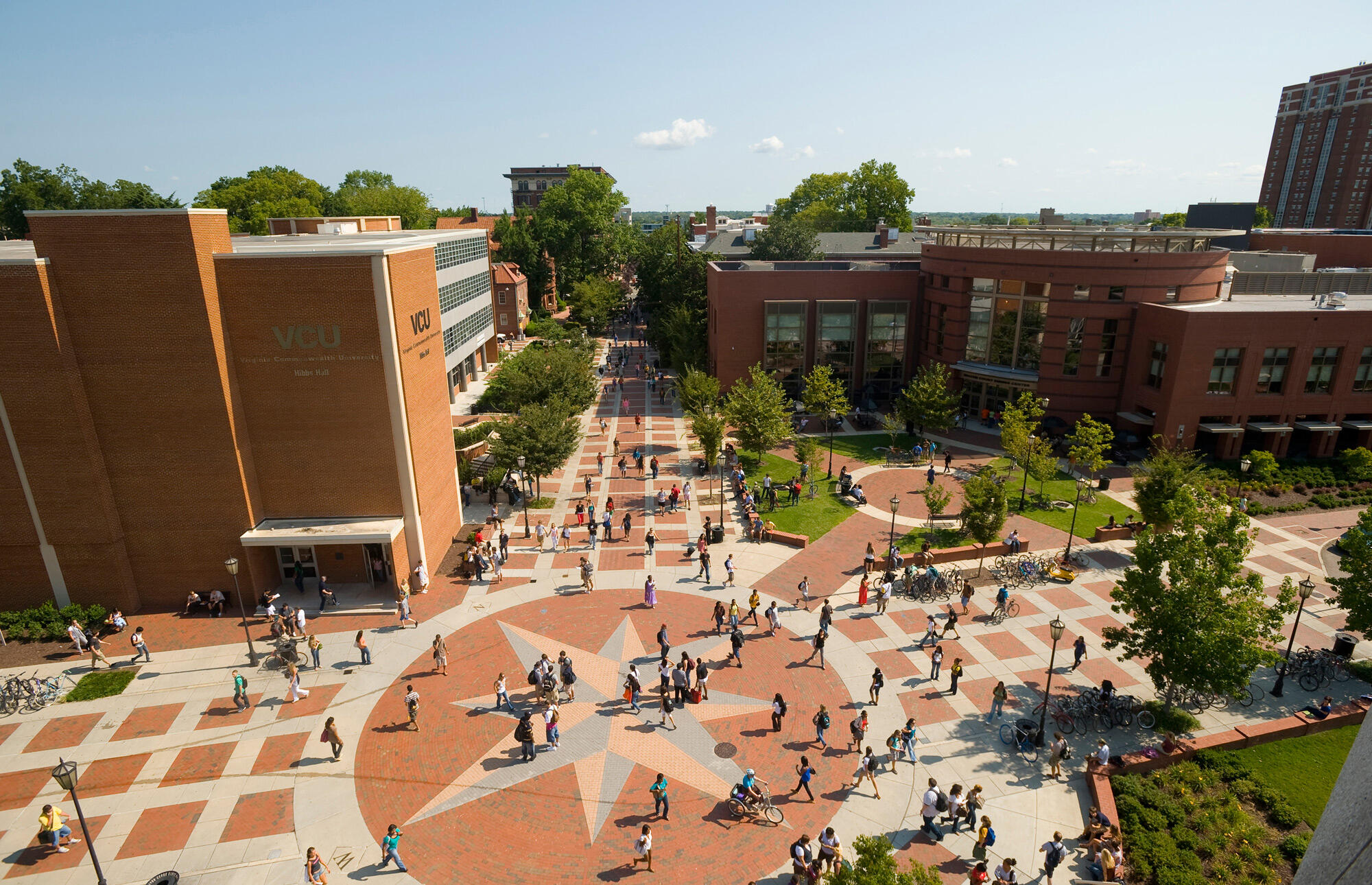 An areal image of the compass courtyard on Monroe Park campus with students walking across it 