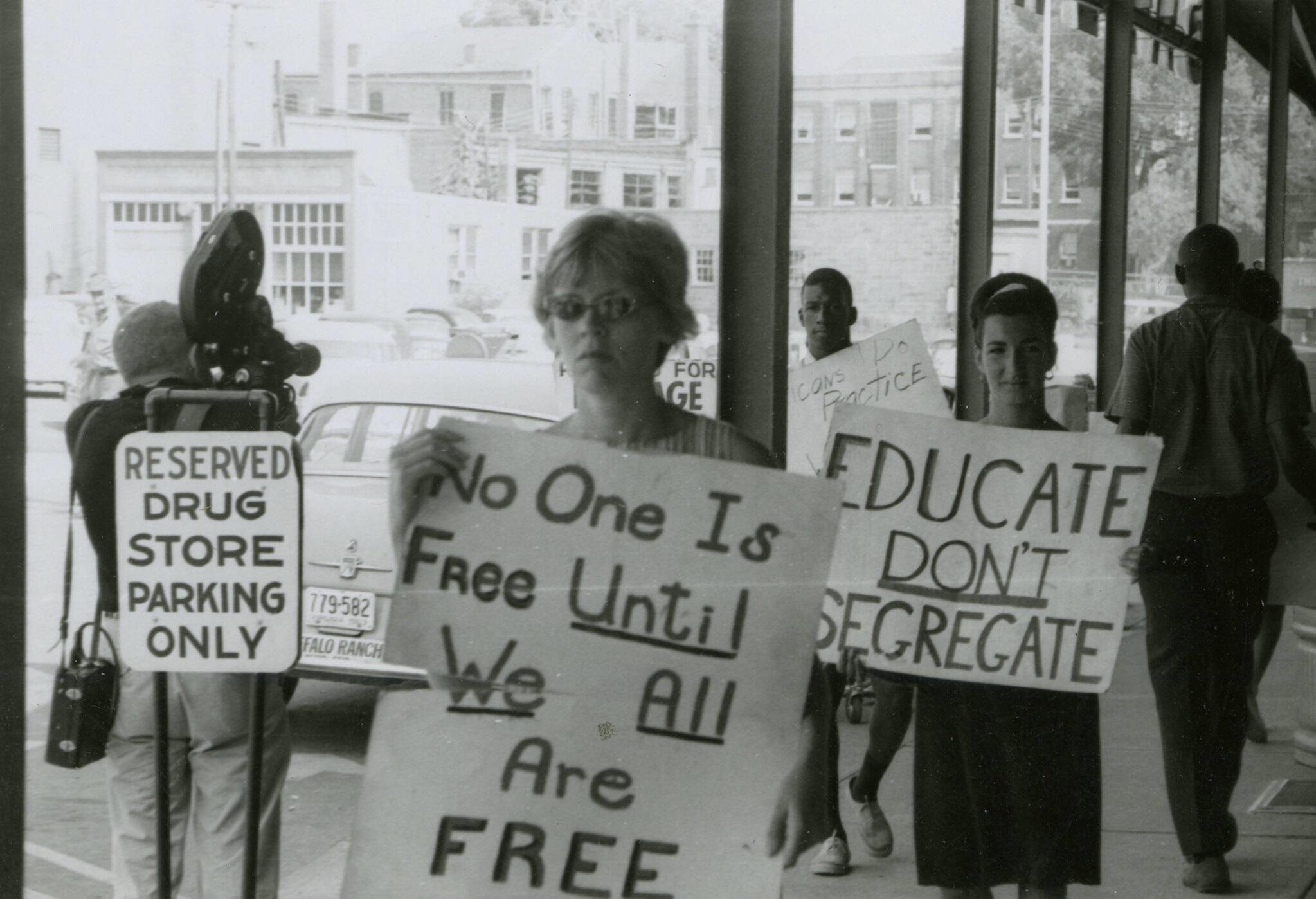 A group of protestors outside a grocery store.