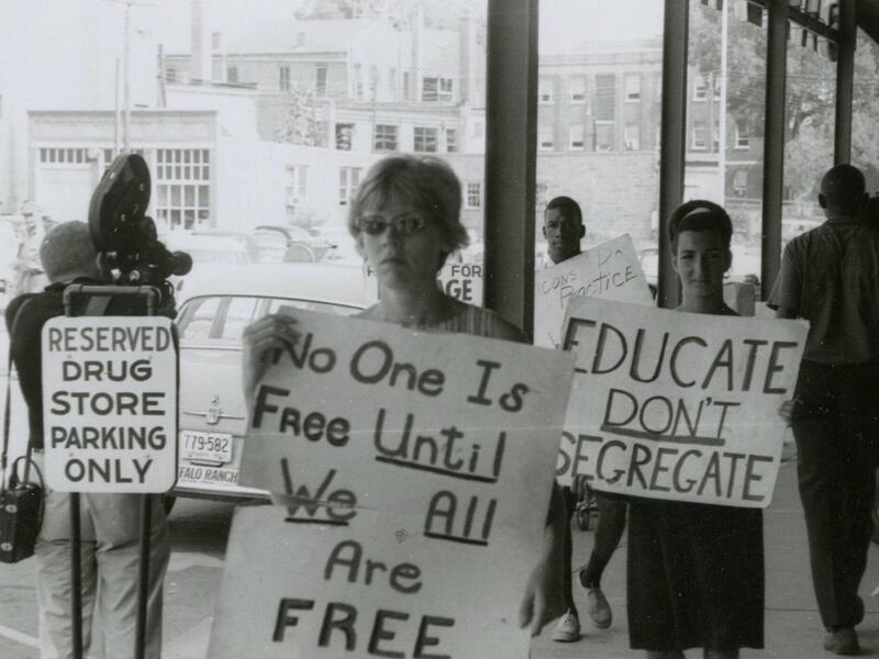 A group of protestors outside a grocery store.