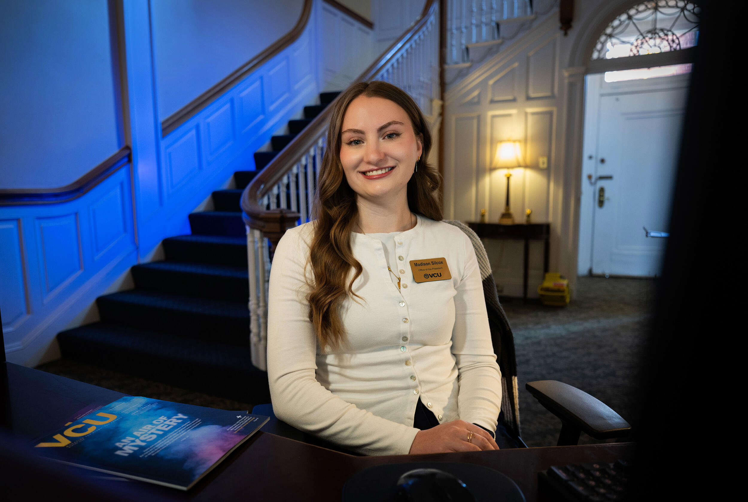 A photo of a woman sitting in a chair. 