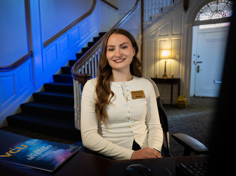 A photo of a woman sitting in a chair. 
