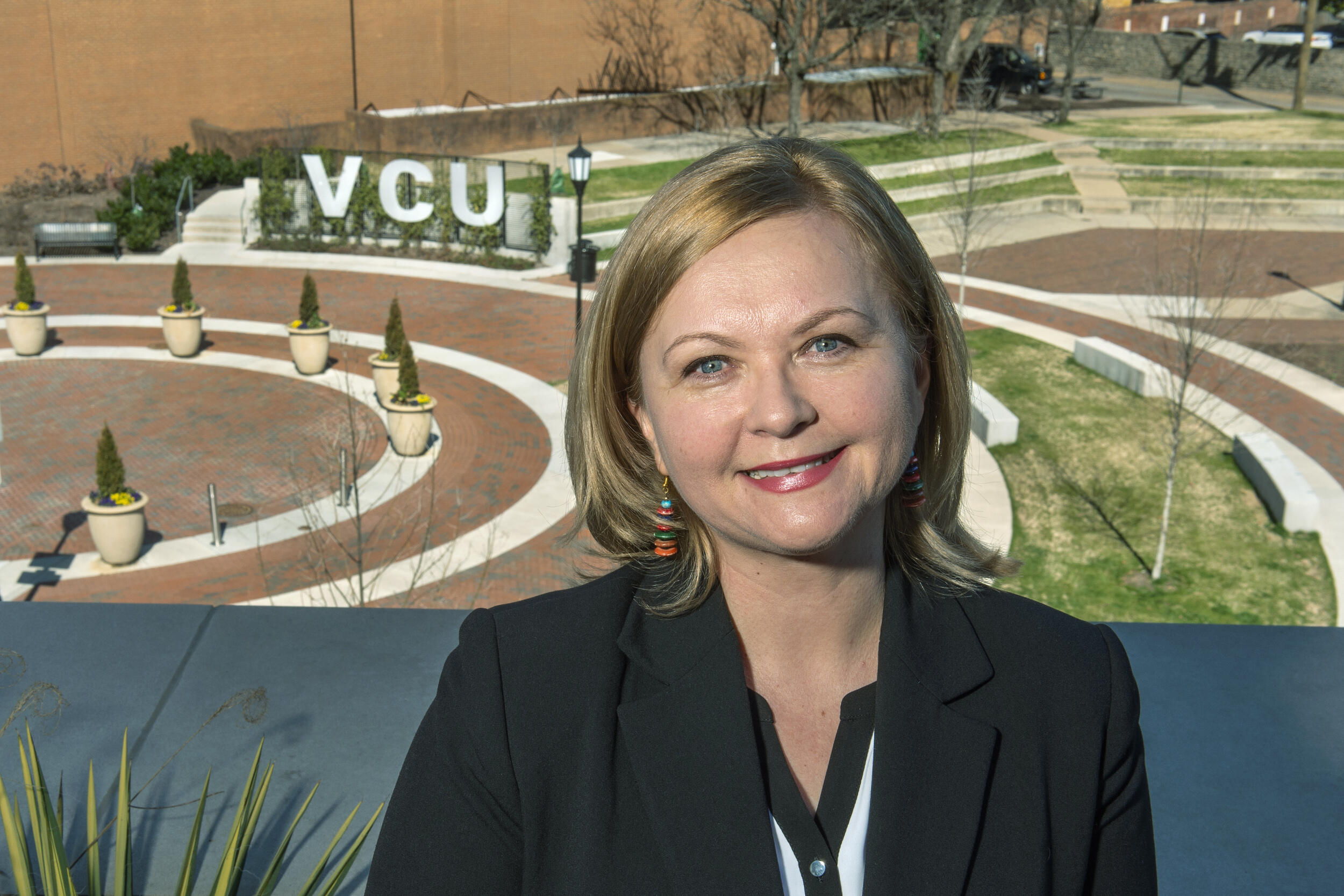 A photo of a woman standing outside. 