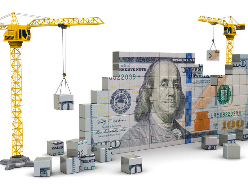 Graphic image of a $100 bill made up of storage containers being assembled by cranes.