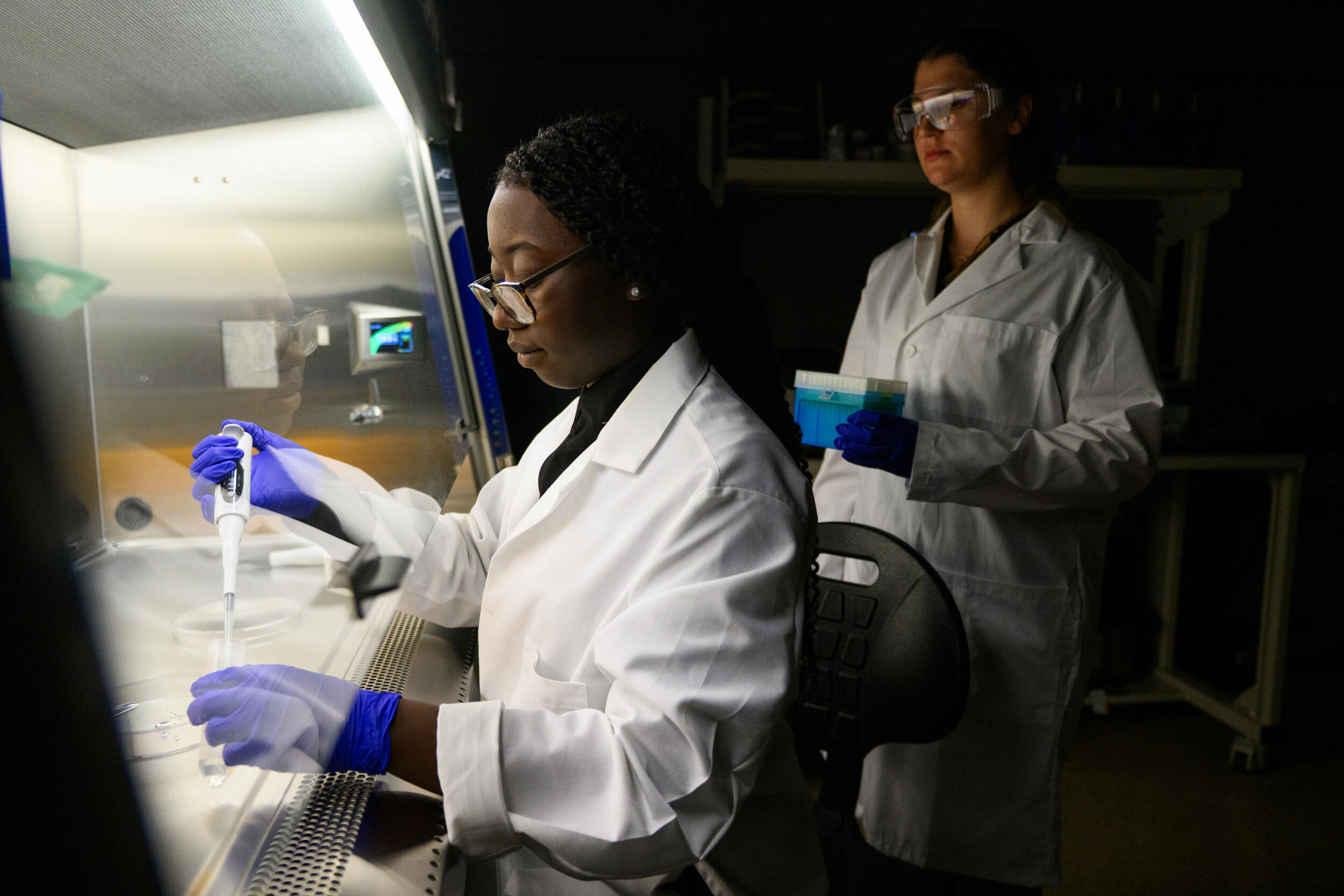 A photo of two women in a science lab. 