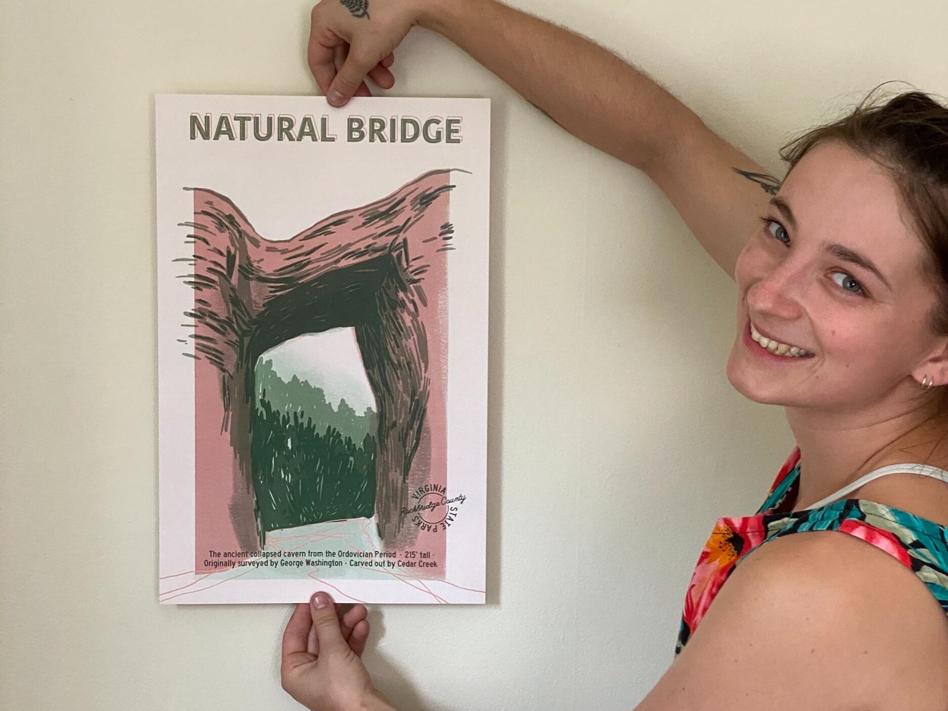 Catherine McGuigan holding up a piece of her artwork.