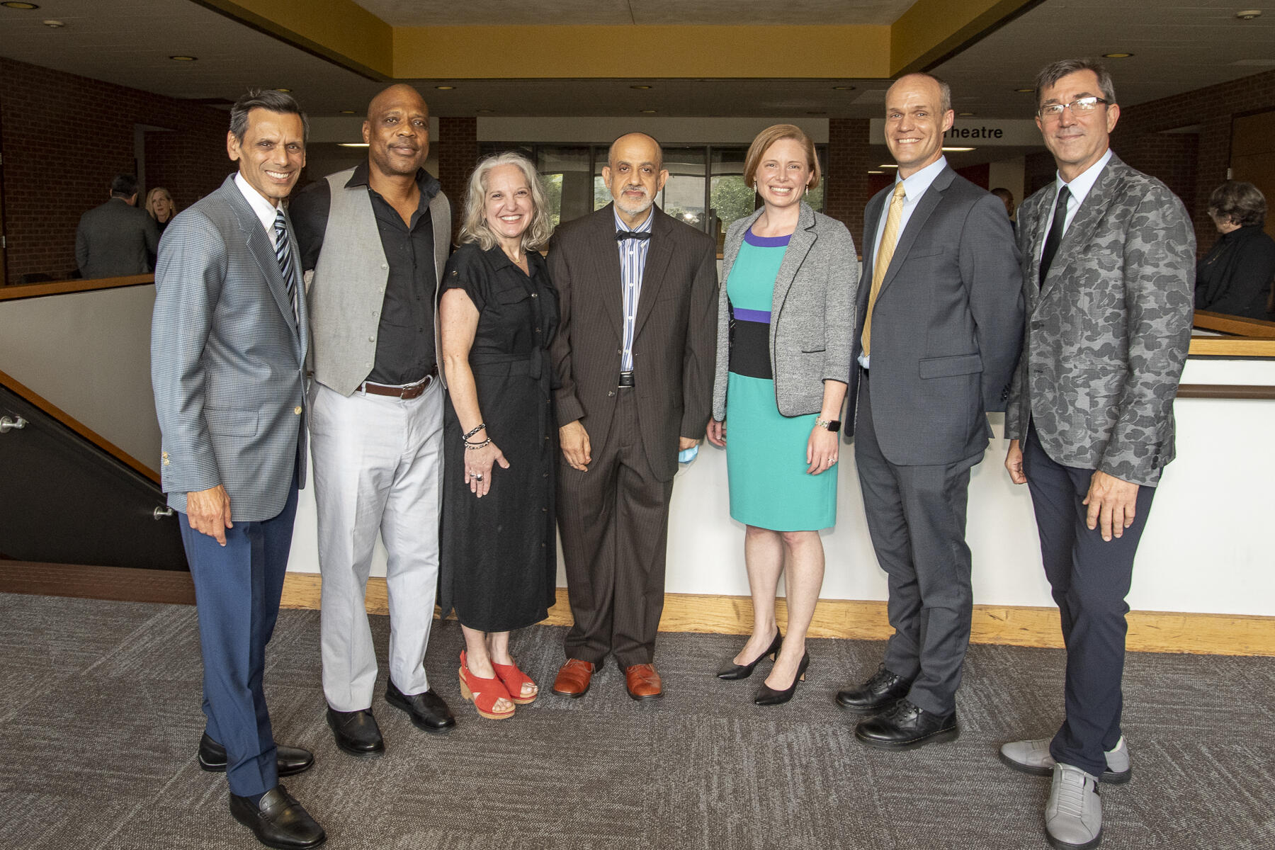 Seven people standing next to each other. 