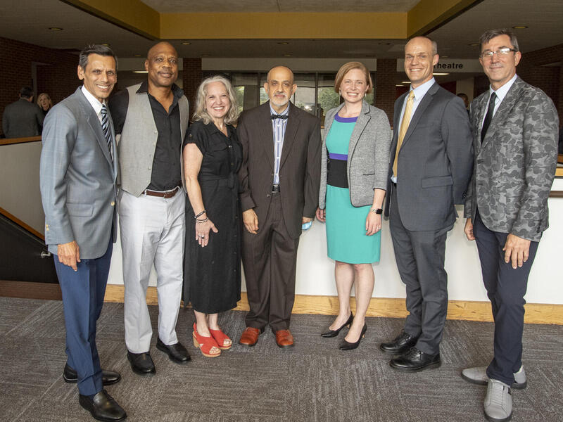 Seven people standing next to each other. 