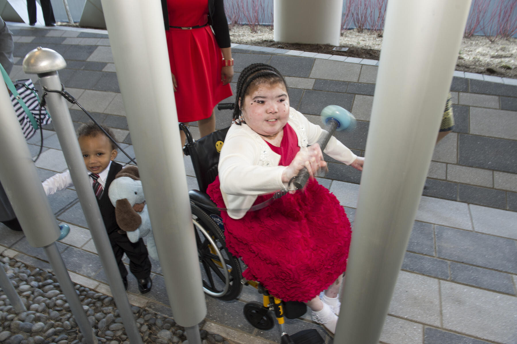 Brianna and Ian play the giant chimes on the Sky Terrace.