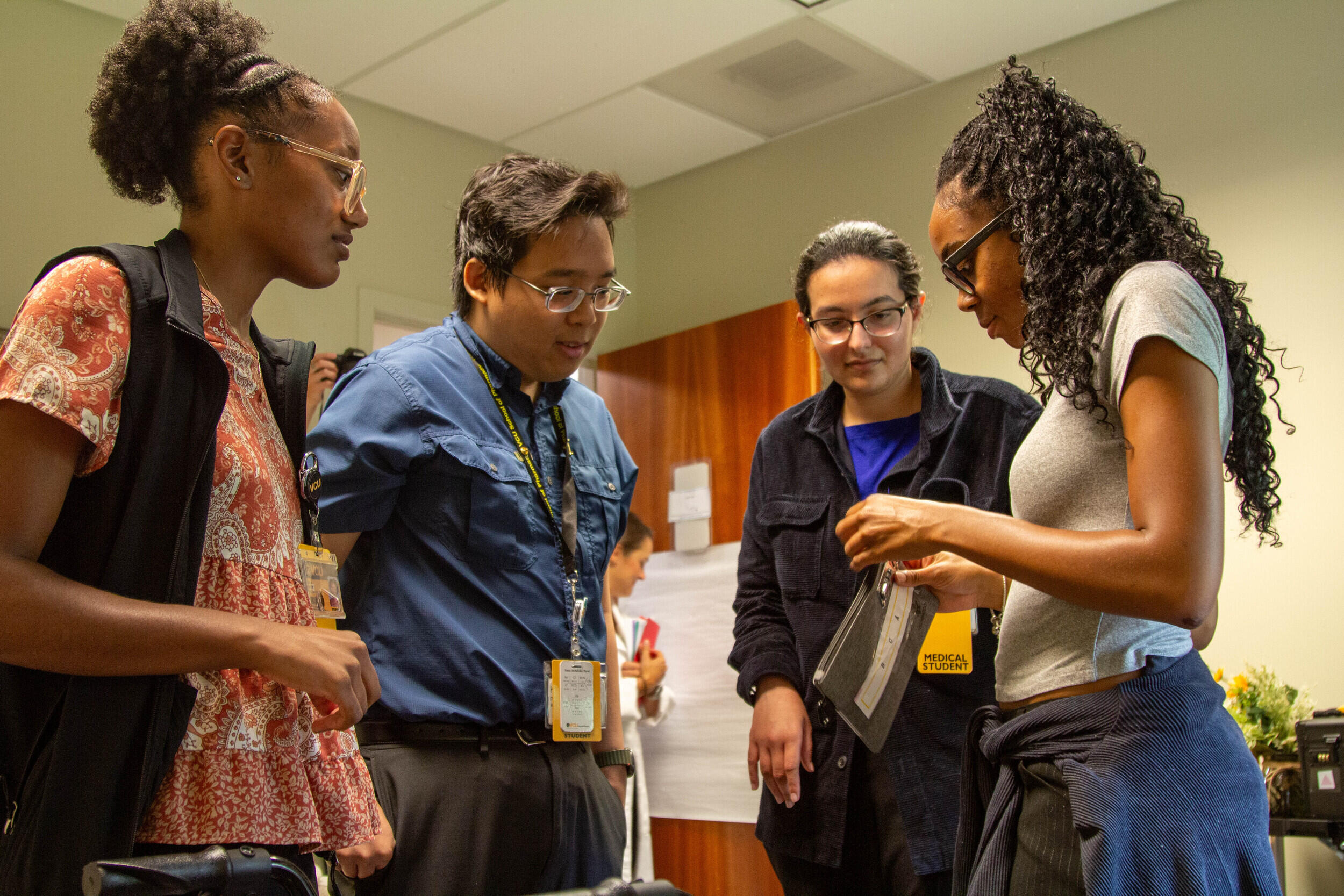 A photo of four people talking. 