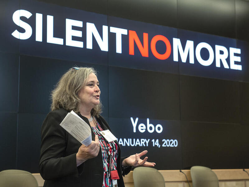 Woman standing during presentation. 