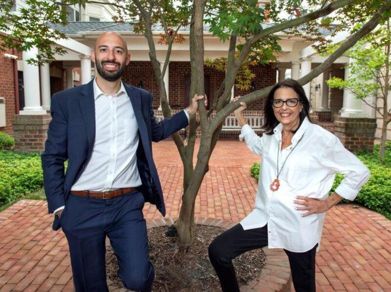 Brent Luper on the left and Karen Luper on the right standing in front of a tree