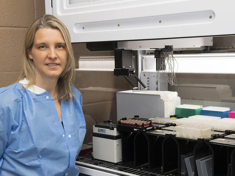 Picture of a woman with lab equipment.