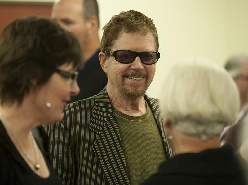 A photo of a man wearing sunglasses in a crowd of people. 