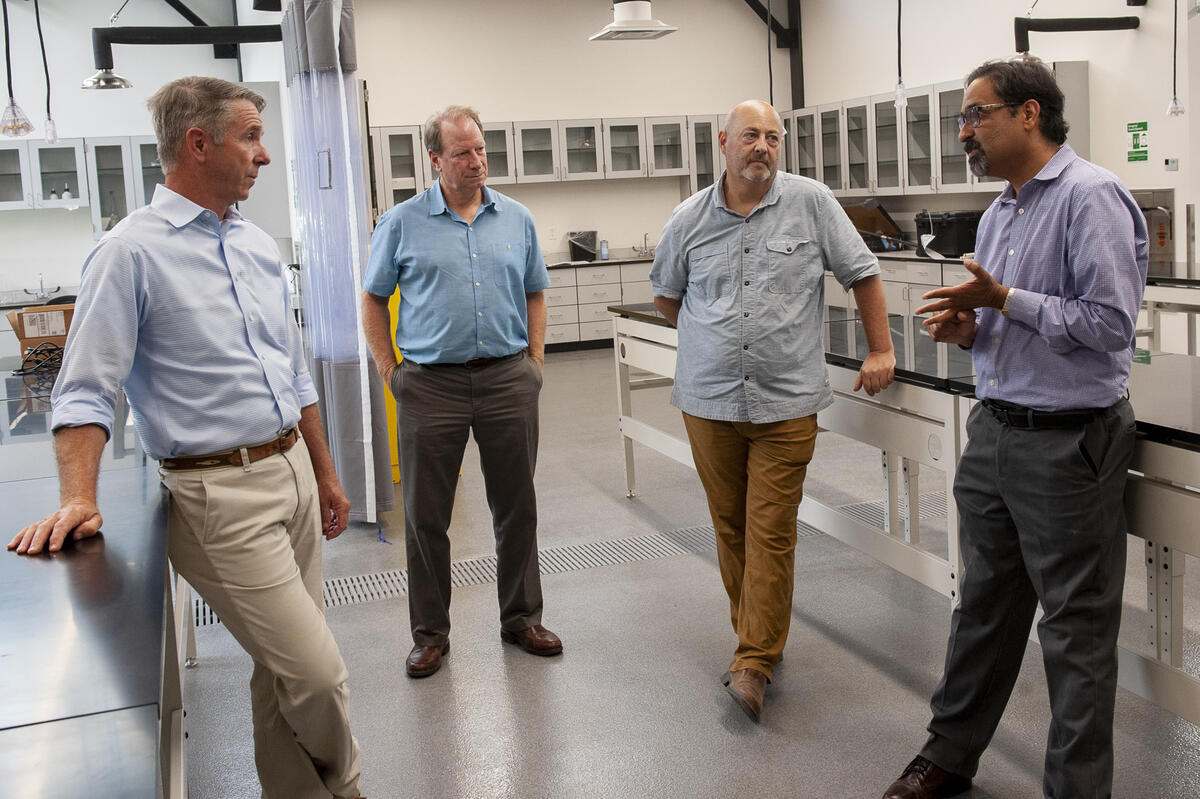 Four men standing in a room
