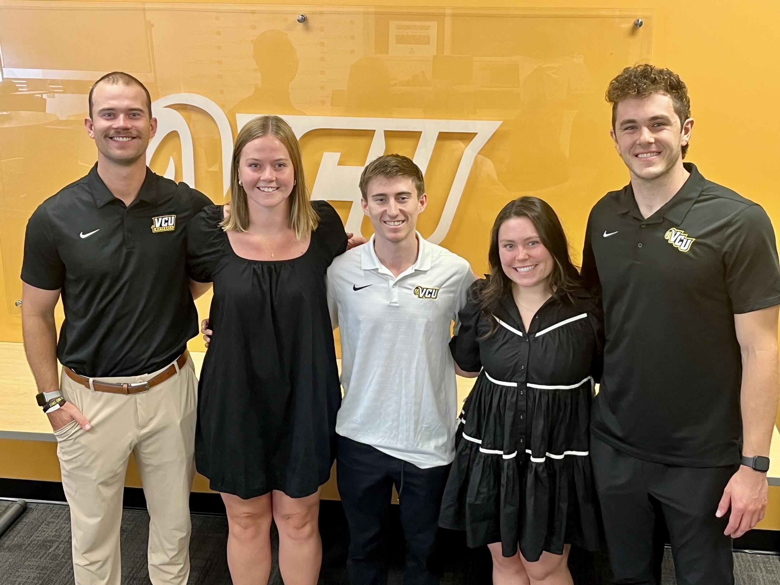 A group photo of five people. 