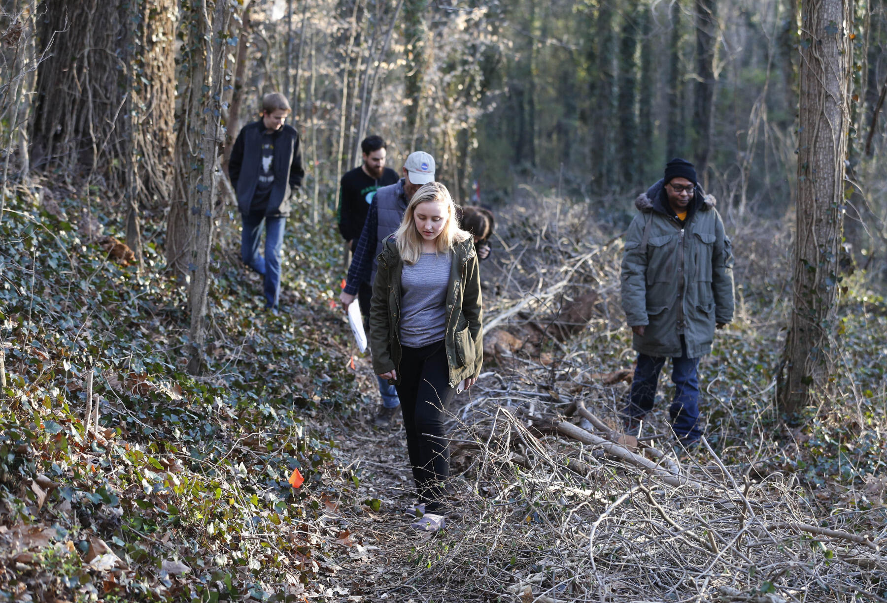 Wilder School students watch their steps as they walk through the cemetery's vine-clogged paths.