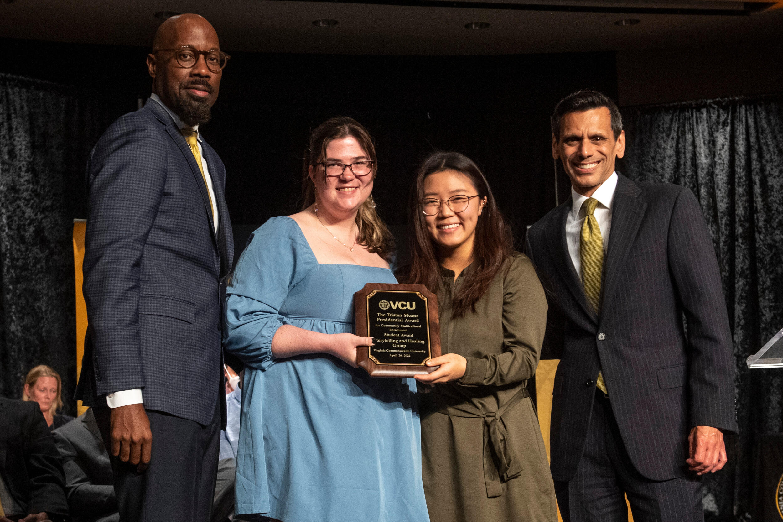 Emma Geisler and Mijin Cho hold a plaque alongside Aashir Nasim and Michael Rao.