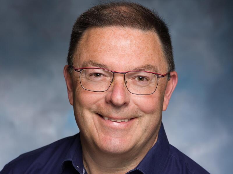 A photo of a man from the shoulders up. 