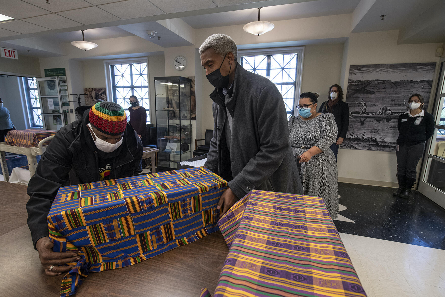Members of the Family Representative Council transport the remains