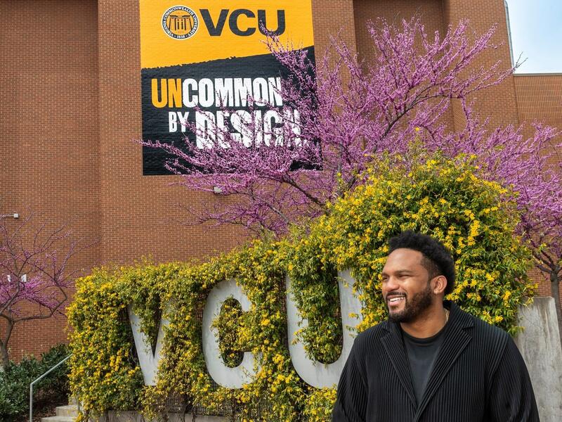 A photo of a man standing outside. 
