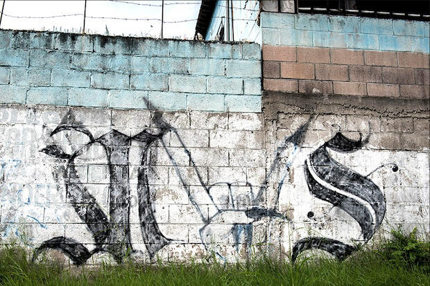 Graffiti inscribed cinder block wall.