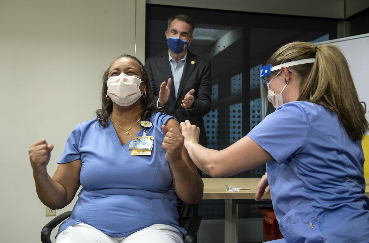 Audrey Roberson reacts after receiving the coronavirus vaccine from Veronica Nolden.