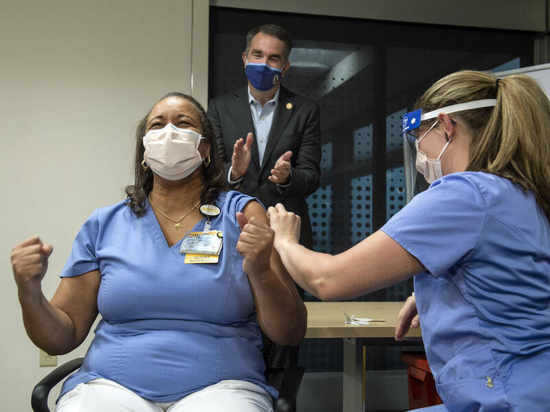 Audrey Roberson reacts after receiving the coronavirus vaccine from Veronica Nolden.