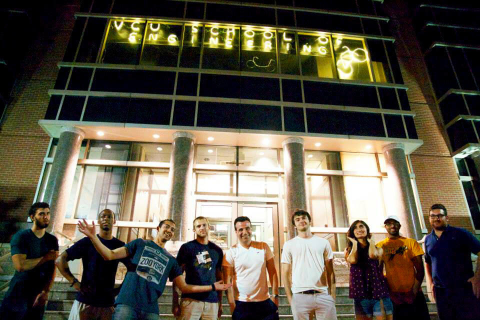After soldering materials together and shaping all the elements for the light display, a group of electrical and computer engineering students pose with Erdem Topsakal, Ph.D. and chair of the Electrical and Computer Engineering department, at 3 a.m. in front of the display.