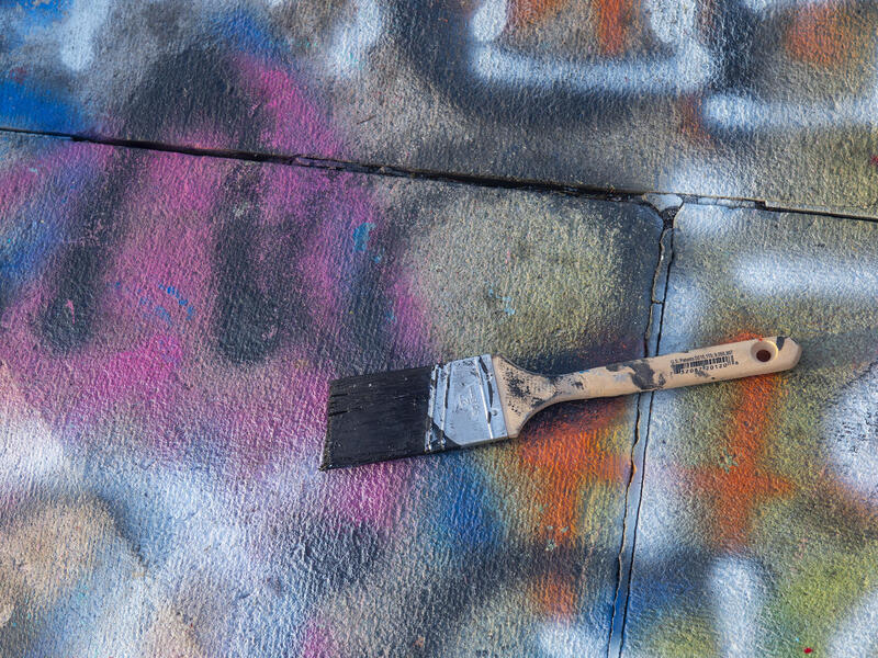 paint brush on a paint-colored sidewalk