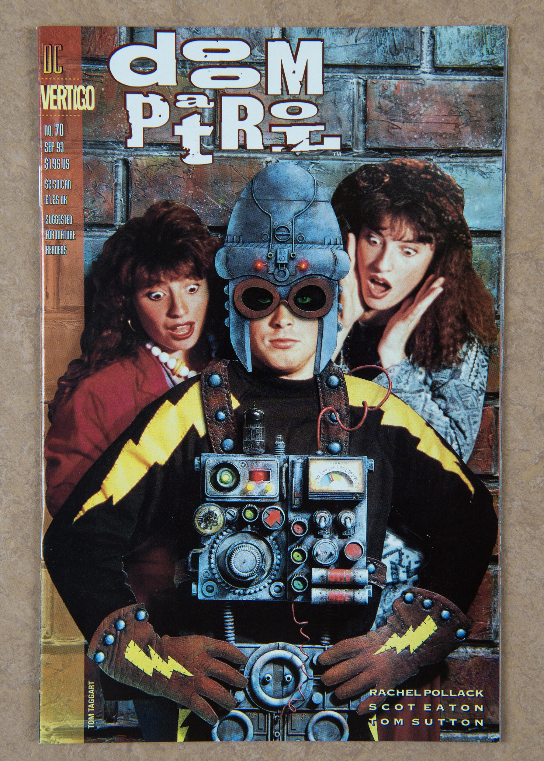 A photo of the cover of a comic book that says \"doom patrol\" in white text. It has an illustration of a man wearing a superhero costume and posing with his hands on his hips. Behind him are two women staring at him with their mouths open and eyes looking down at him. 