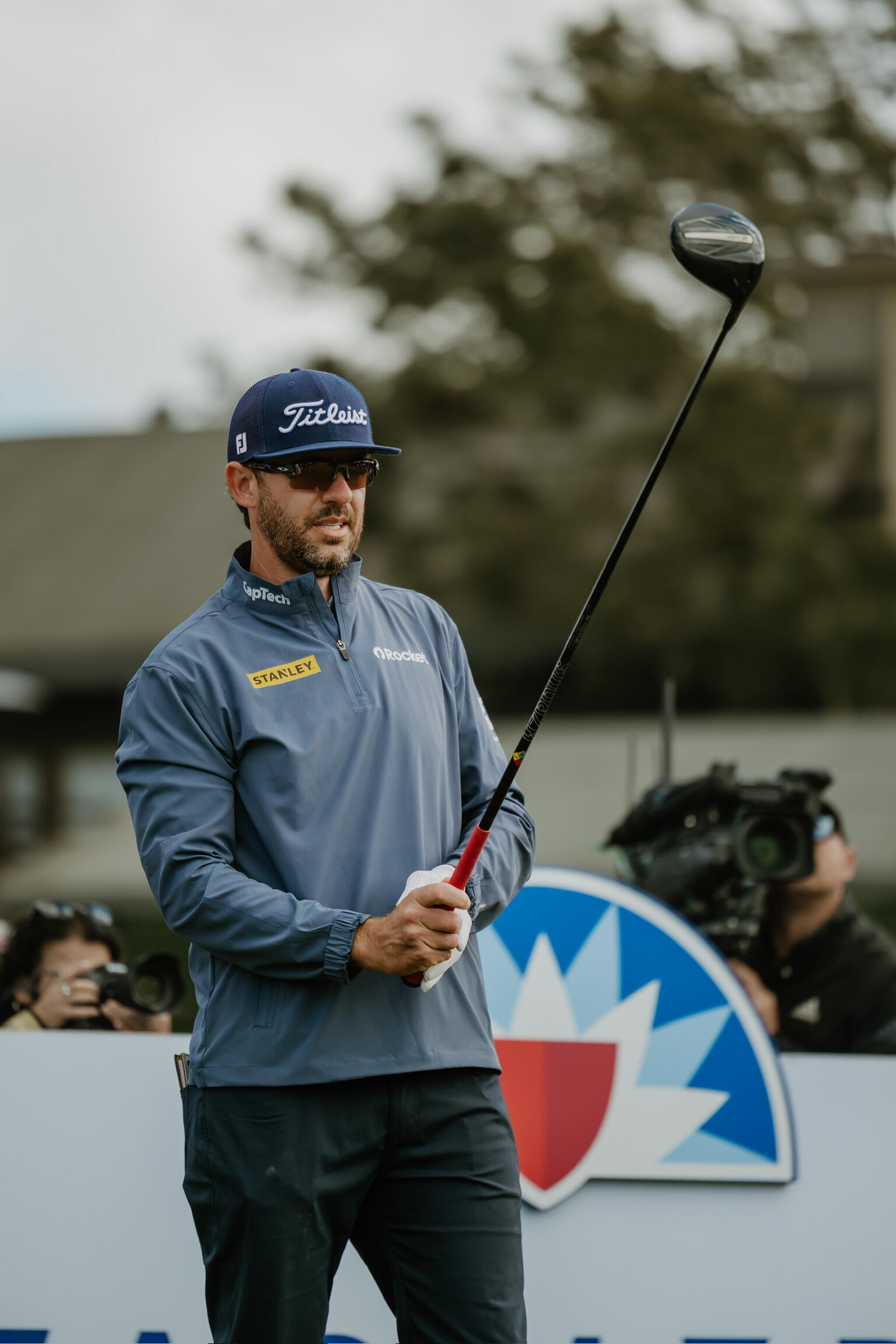 A photo of a man holding a golf club. 