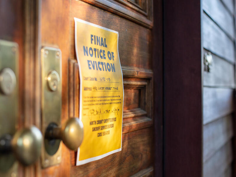 An eviction notice posted on the door of a building.