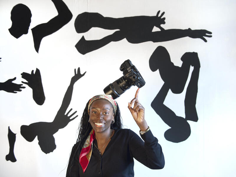 A photo of a woman pointing the index finger of her right hand in the air