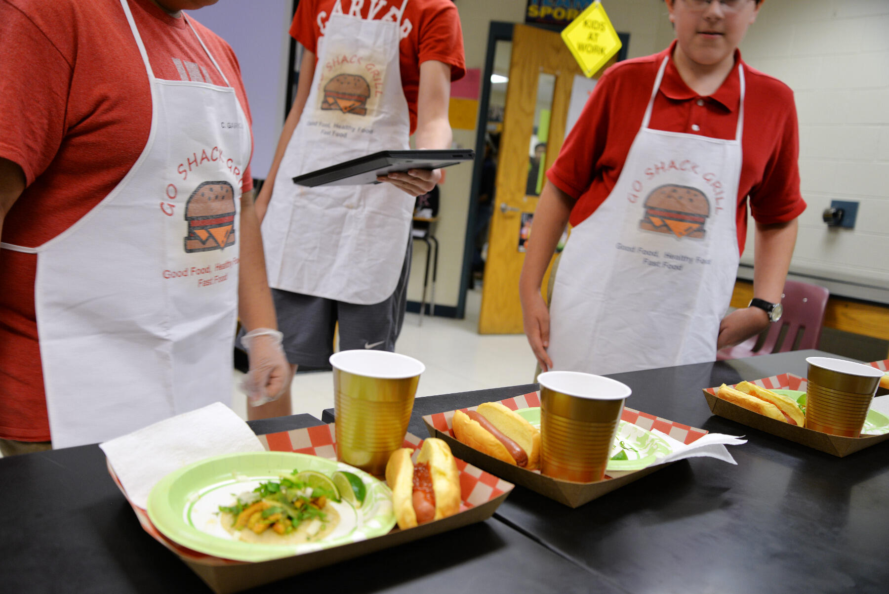 Students pitching a restaurant called "Go Shack Grill" handed out samples of their spicy tacos and hot dogs.
