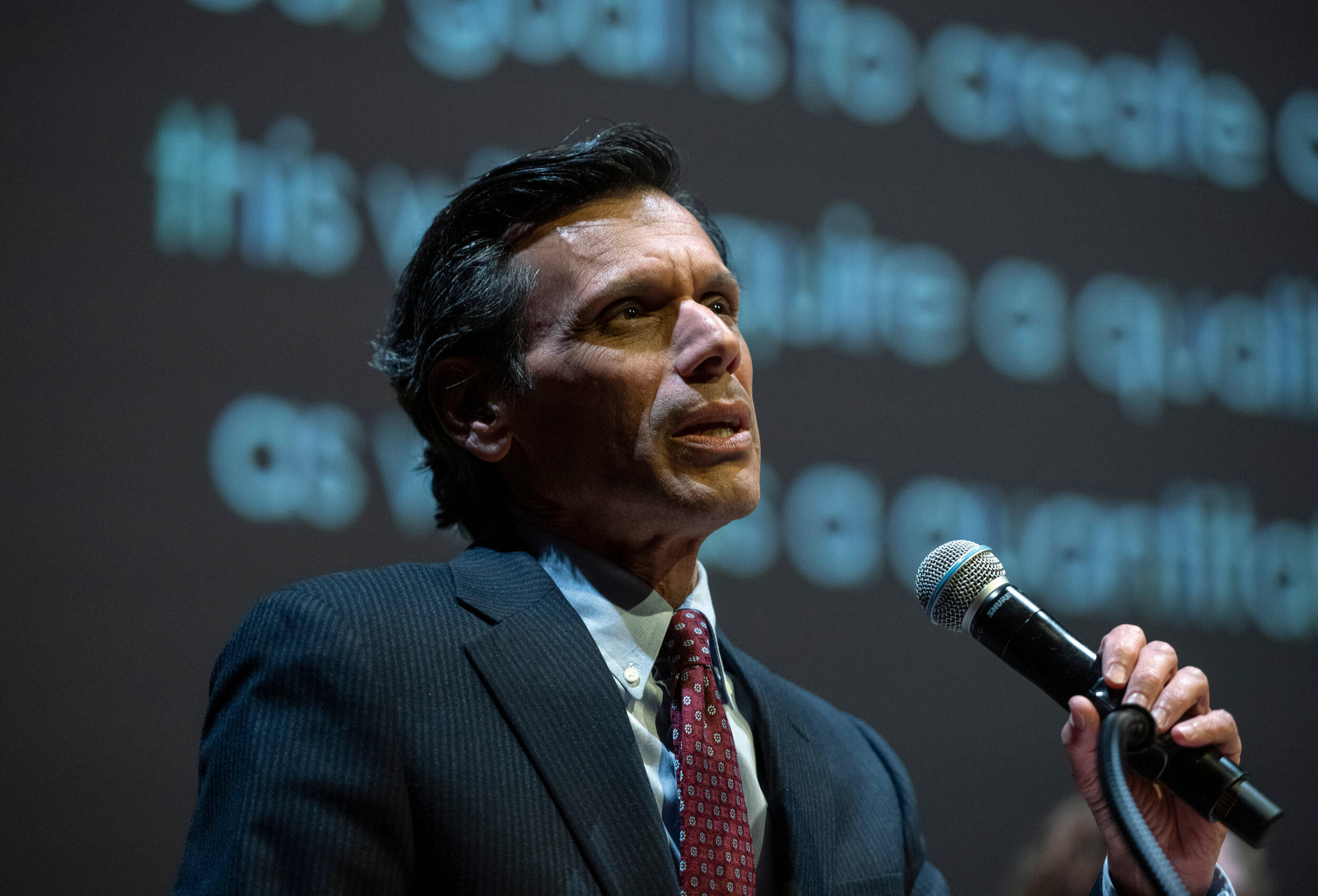 Man speaks into a microphone.