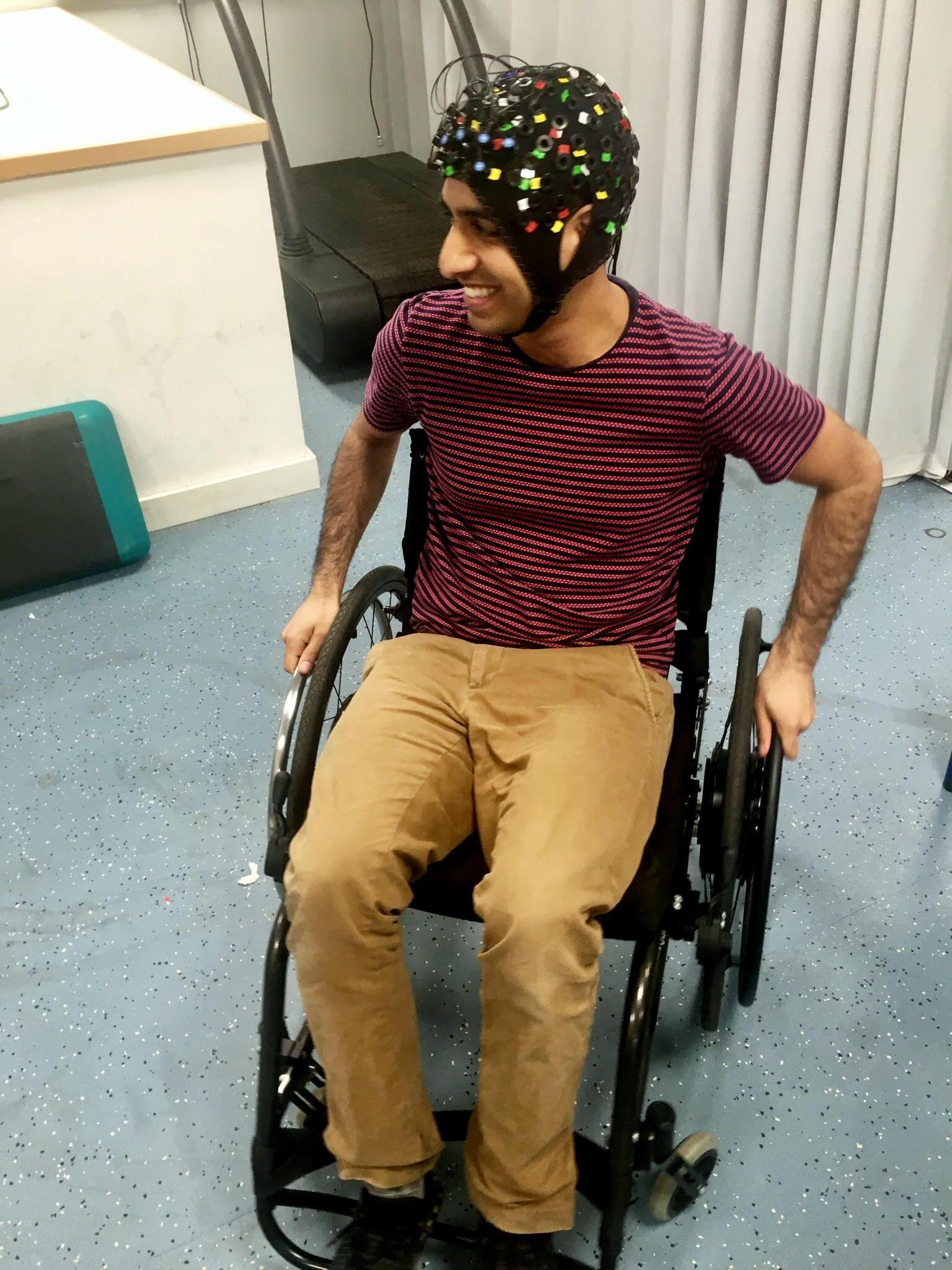 Joshi demonstrates how the functional Near Infrared Spectroscopy device is worn.