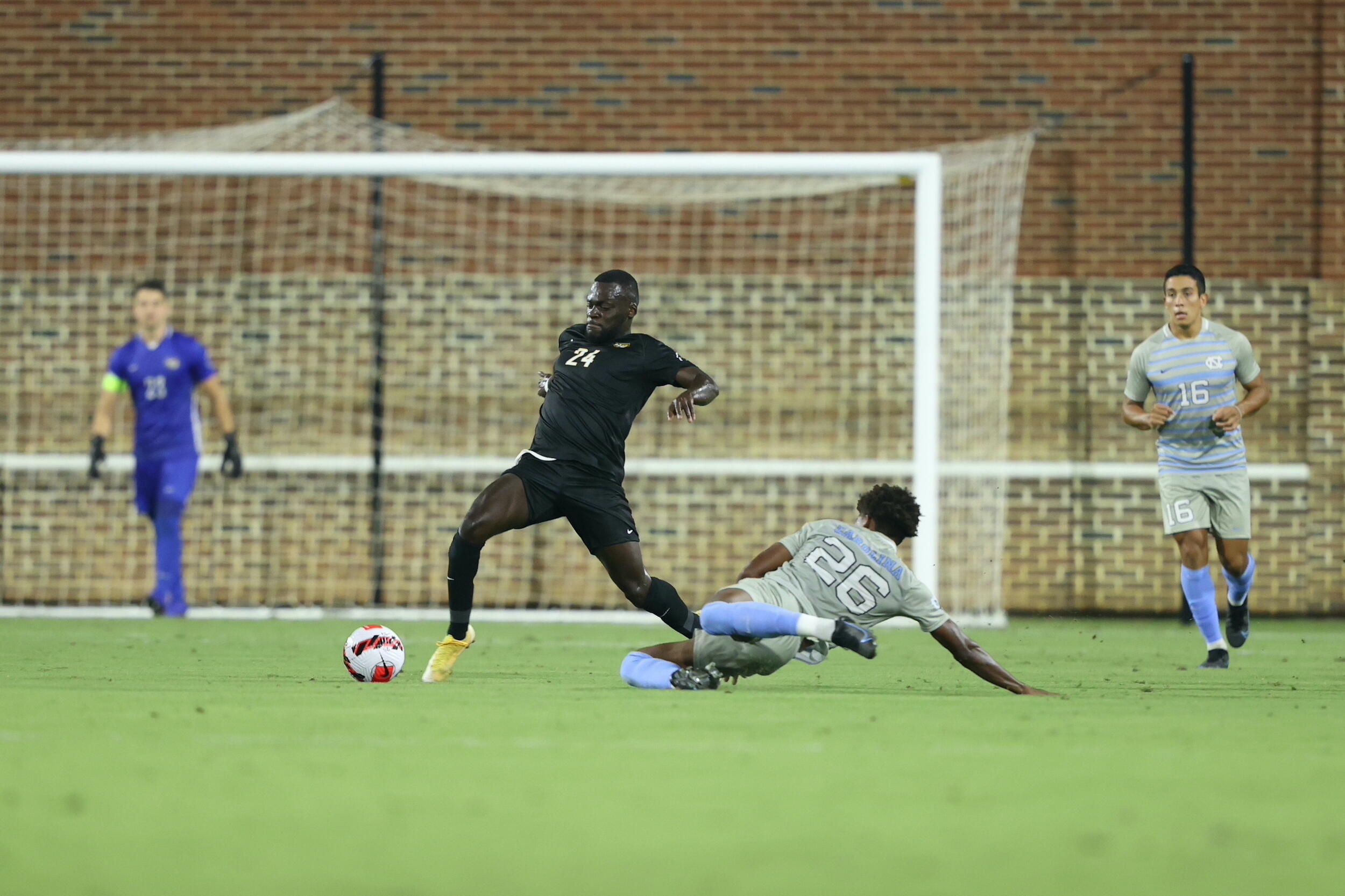 Andy Mensah fights for possession during VCU's soccer game against the University of North Carolina.