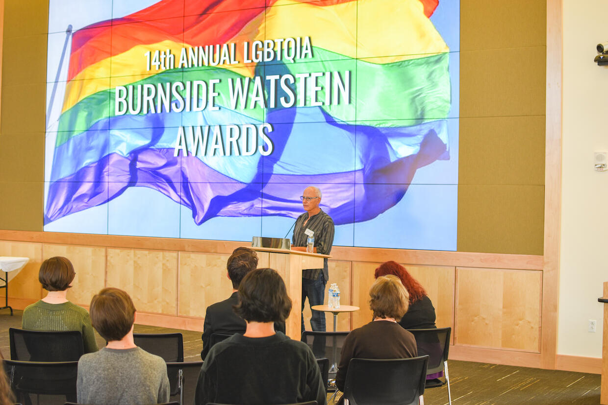 A person speaking in front of an audience. 