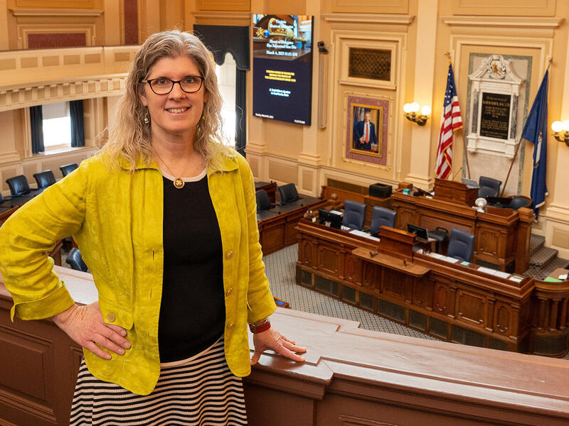 Tricia Vaughan stands in the balcony at the Virginia Capitol.