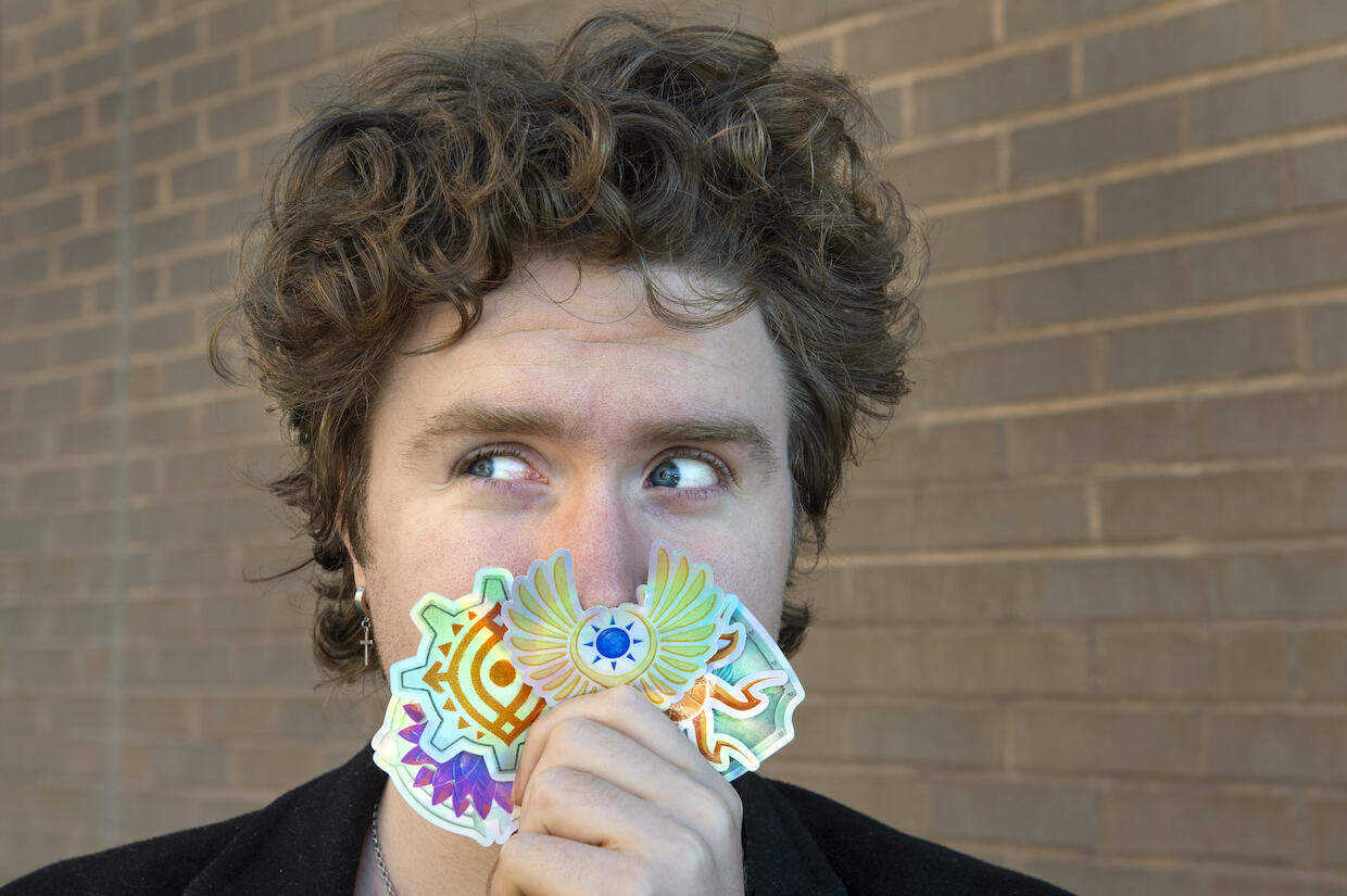 Shaw Schiappacasse holding stickers.