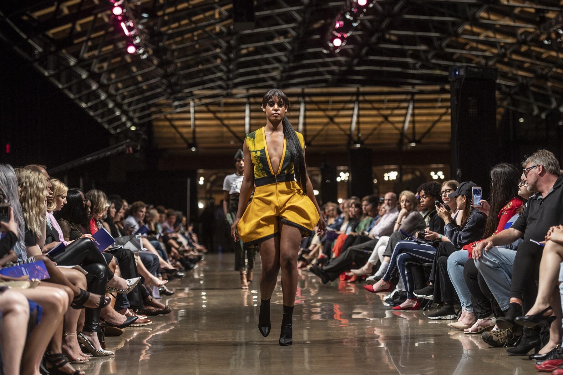 A reservist in the military, Phyllis Sachi-Solomon designed a collection of military flight suits with a feminine touch for her collection in this year's VCU School of the Arts annual Juried Fashion Show, “Momentum.” (Photos by Allen Jones, University Relations)