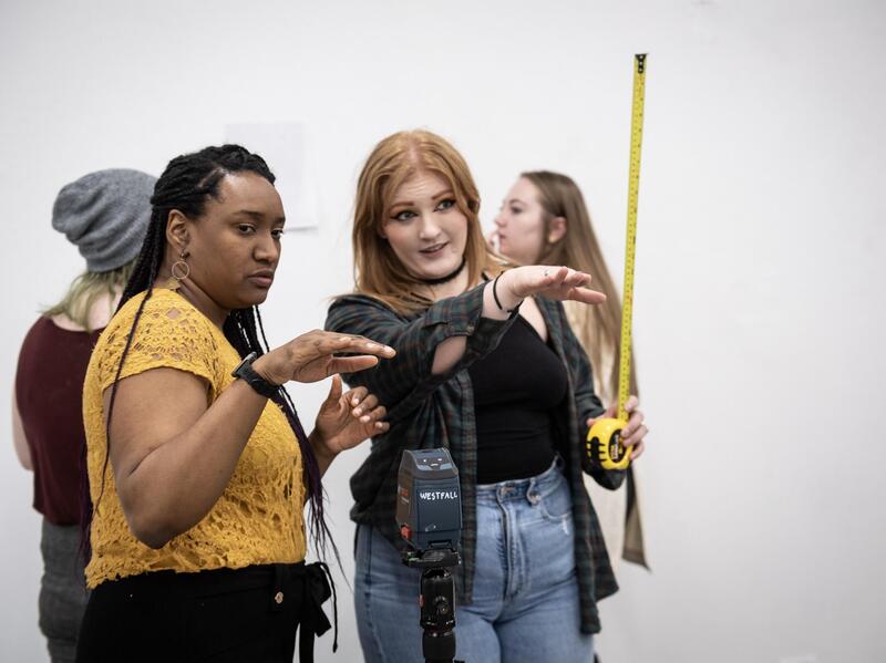 fou people standing in a white room