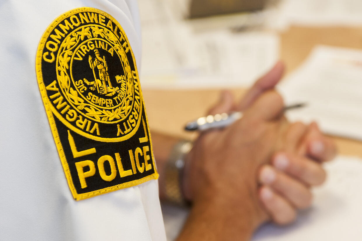 A person with the V C U Police Department seal on their shirt sleeve.