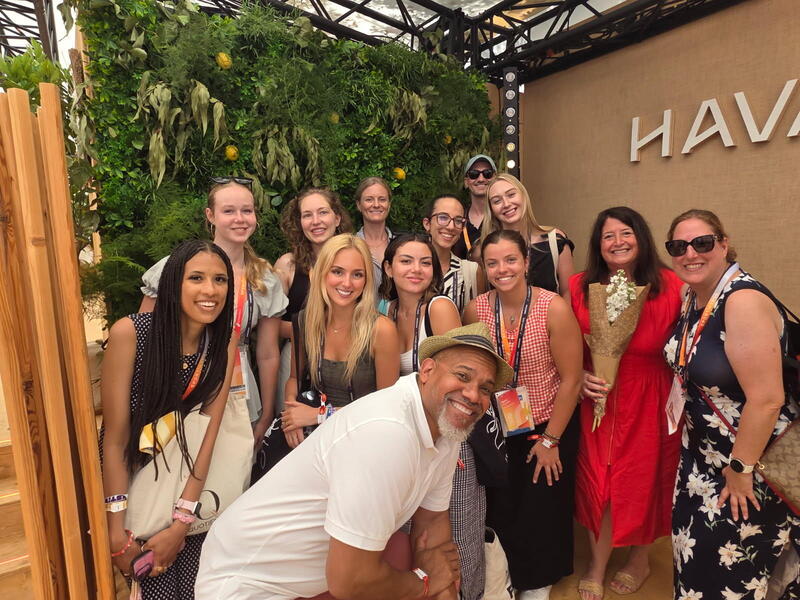 A group photo of 13 people. 