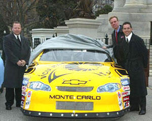 From left: B.J. Burton, associate athletic director for marketing and promotions at VCU, Gov. Mark Warner and Hermie Sadler unveil VCU's Winston Car Cup during a ceremony at the State Capitol.

Photo by Steve Rose, MotorSports Memories