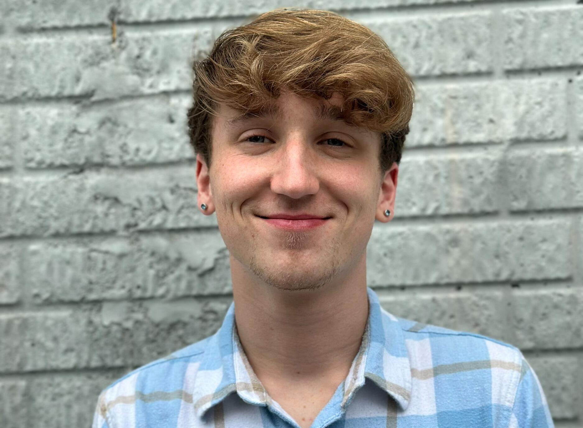 A photo of a man from the shoulders up. 