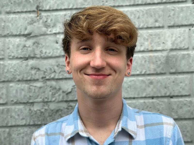 A photo of a man from the shoulders up. 