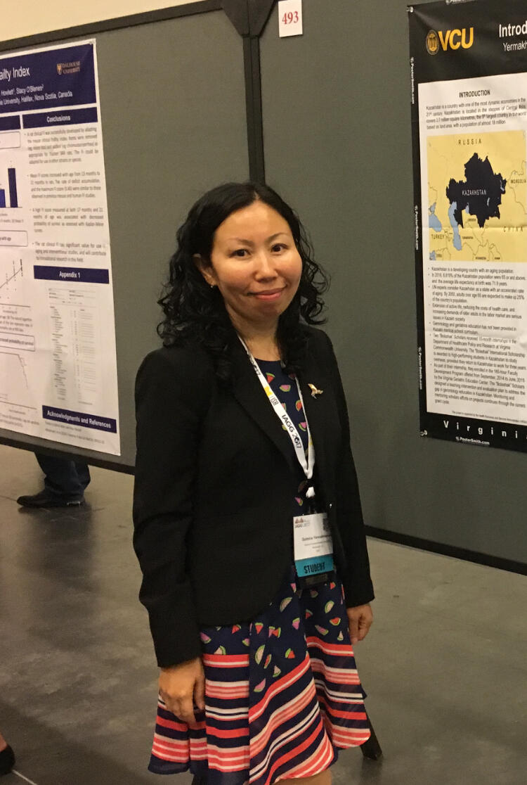 Person in business attire standing by a poster presentation