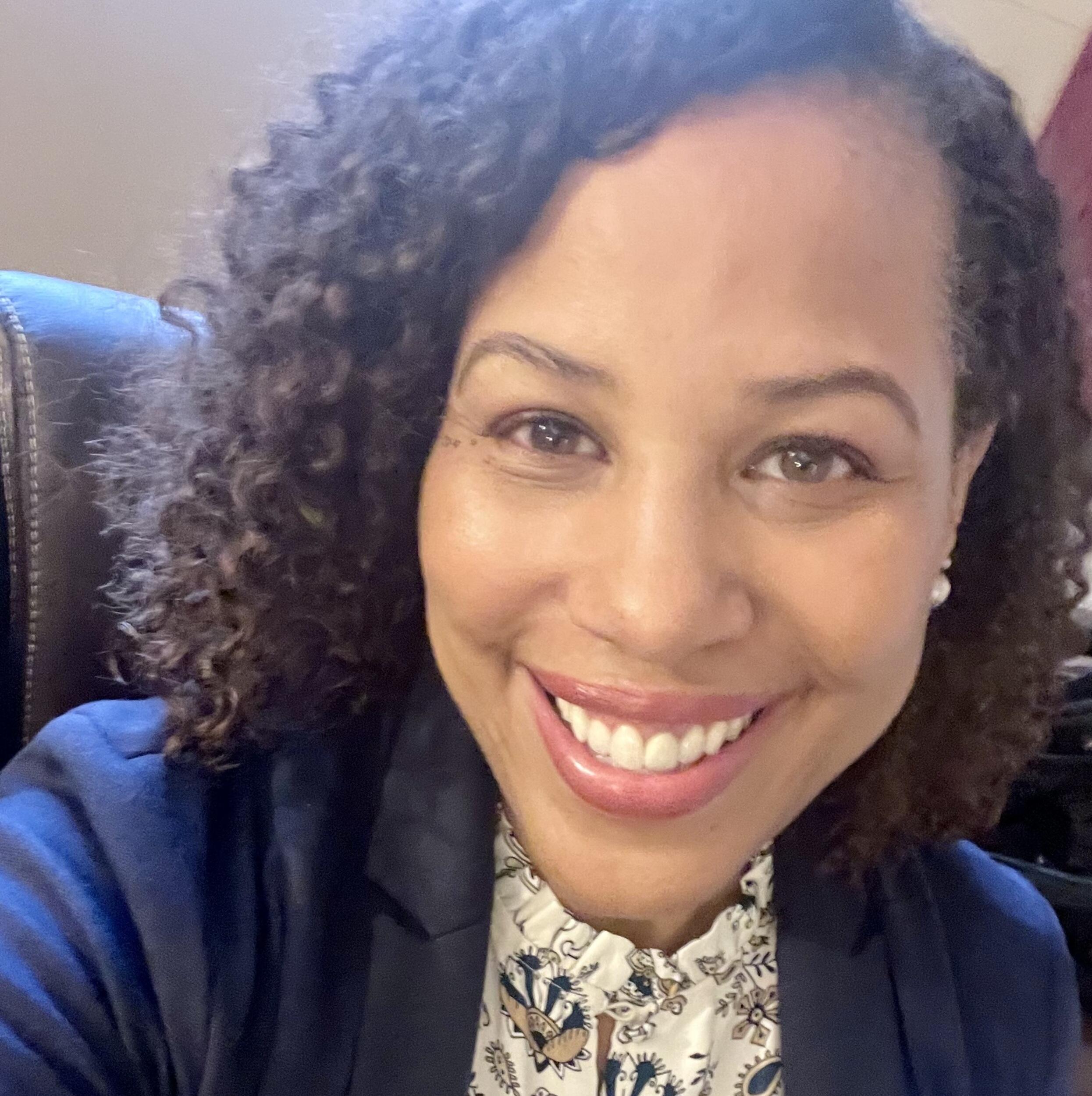 A photo of a woman from the chest up. 