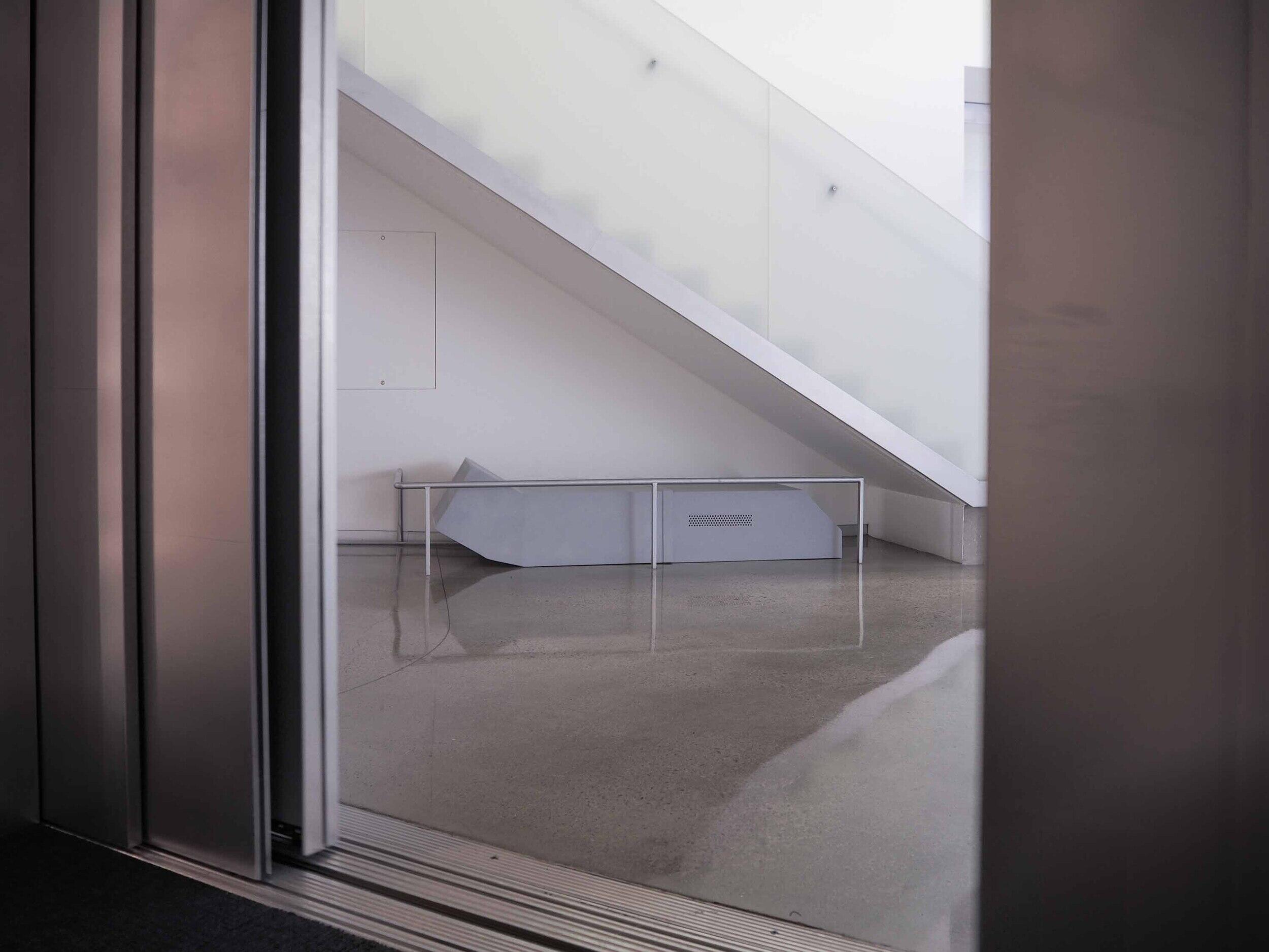 A photo of a door opening to relveal a staircase. 